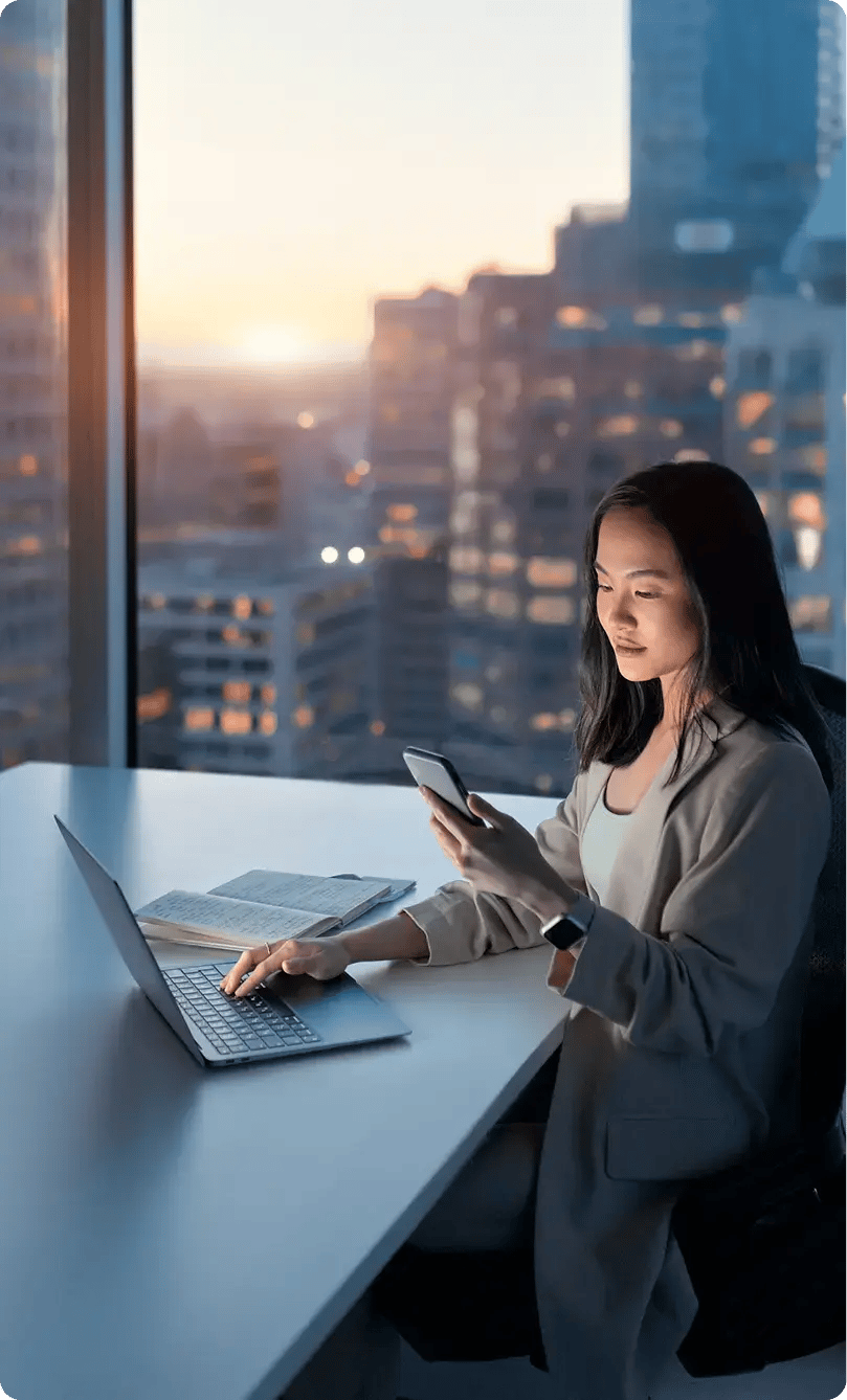 Woman reviewing staffing options on phone and computer